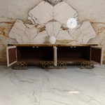 Luxury TV Stand with Textured Upholstered Panels Geometric Stainless Steel Base and Spacious Cabinet Storage